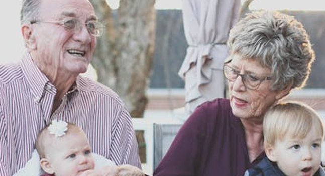 Grandparents with their grandchildren sitting on their knee