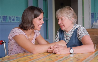 Picture of two female adults sitting at a table.