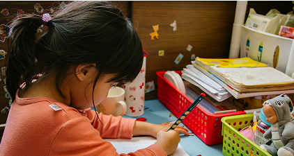Child drawing at a desk